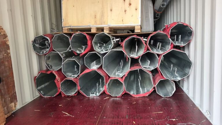 Galvanized octagonal steel poles packed inside a container for the Burundi overhead line project