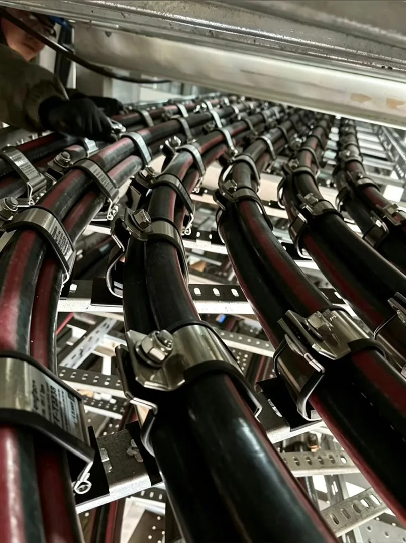 Stainless steel cable cleats installed on cable tray for power cable fixing